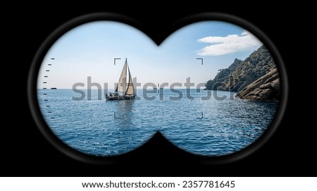 Binoculars point of view with a white sailing boat in motion in the blue Mediterranean sea, San Fruttuoso bay between Portofino and Camogli, Genoa province (Genova), Liguria, Italy, Europe.