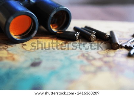 Binoculars and reflection in lenses. Map background.