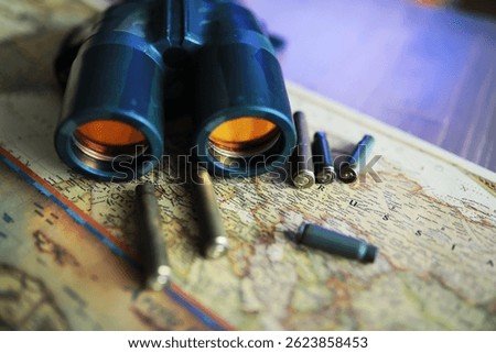 Binoculars and reflection in lenses. Map background.