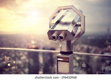 Binoculars or telescope on top of skyscraper at observation