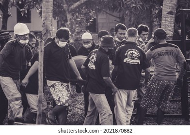 Bintan Island, July 2021, Feast of Sacrifice, Eid al-Adha, people working together to slaughter cows at the mosque - Shutterstock ID 2021870882