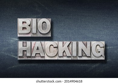 Bio Hacking Phrase Made From Metallic Letterpress On Dark Jeans Background