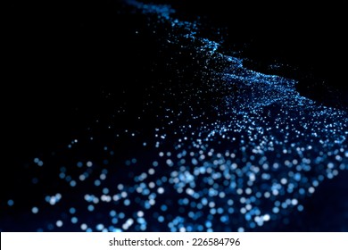 Bio luminescence. Illumination of plankton at Maldives. Many bright particles.