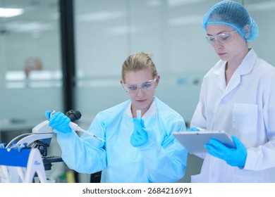 In a bio manufacturing facility, scientists develop a personalized mRNA vaccine, using a digital tablet to guide the precise formulation for a next generation gene therapy treatment.