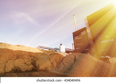 Bio Power Plant With Storage Of Wooden Fuel (biomass) Against Blue Sky
