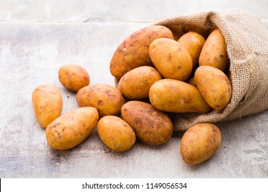 A bio russet potato wooden vintage background. - Shutterstock ID 1149056534