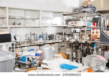Biochemical laboratory interior with different lab equipment and glassware