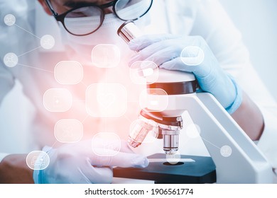 biochemical research scientist working with microscope for coronavirus, laboratory glassware containing chemical liquid for design or decorate science, chemistry, biology, medicine and people concept  - Powered by Shutterstock