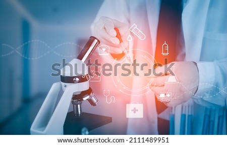 biochemical research scientist working with microscope for coronavirus, laboratory glassware containing chemical liquid for design or decorate science, chemistry, biology, medicine and icon concept 