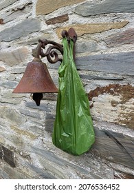 Biodegradable Dog Poop Bag Hanging On An Outdoor Bell.