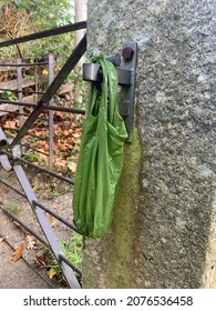 Biodegradable Dog Poop Bag Hanging On A Gate Catch.