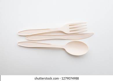 Biodegradable plastic spoon, fork and knife on white background isolate