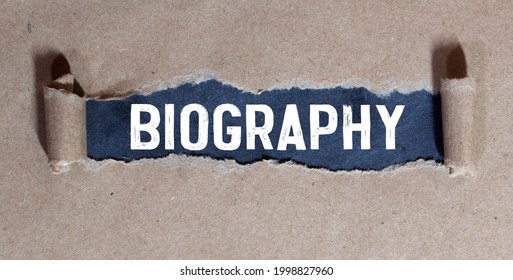 Biography On Blackboard With Cup Of Coffee, With Glasses On Wooden Background.