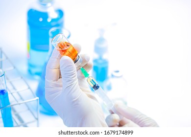 Biologic Treatment. Syringe Pierced Medicine Bottle. Pharmaceutical Science Research In Laboratory Bio Technology. Scientists Are Doing Science Experiments To Find Effective Vaccines. Cure Concept.