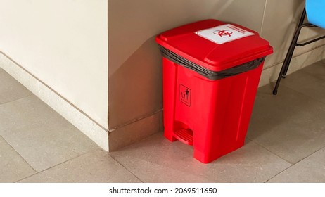 Biological biohazard infected red bins at the corner. Sign showing the biological hazard symbol.
