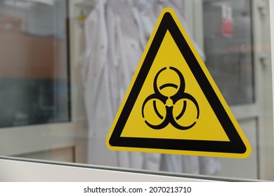Biological hazard sticker on the doors to cell culture laboratory. Biohazard is a biological substance that poses a threat to the health of living organisms, primarily humans - Shutterstock ID 2070213710