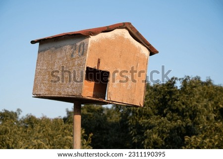 Biological pest control: Man made birdhouse, designed for The Barn Owl (Tyto alba), mounted on a pole in an avocado orchard 
