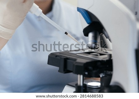 Biological sample preparation using laboratory micropipette before microscope examination in a modern clinical laboratory