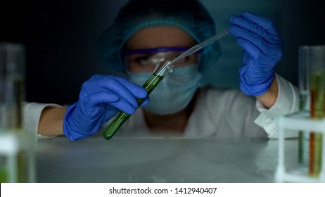 Biologist Dripping Liquid In Tube With Green Plant, Biofuel Production, Industry