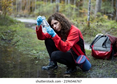 Biologist Environmentalist Woman Taking Samples Of Water And Soil In A Forest Environment