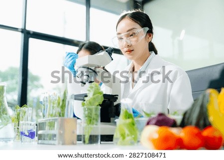 Biologist taking experiment with plants working in biochemistry laboratory. 
