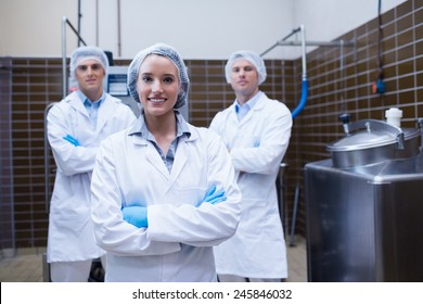 Biologist team standing smiling with arms crossed in the factory