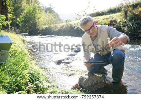 Biologist testing water quality of river