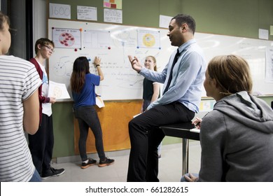 Biology Teacher Teaching In Class With Diverse Of High School Students