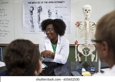 Biology teacher teaching biology to diverse group of high school students - Powered by Shutterstock