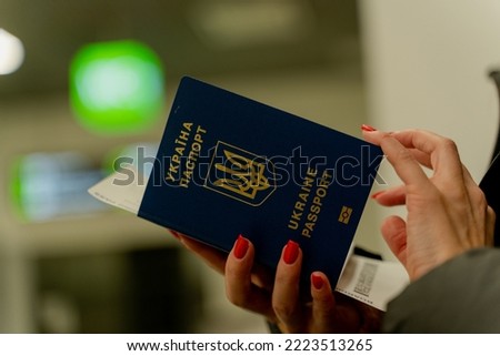 Biometric passport of Ukraine. A woman's hand flips through a passport.