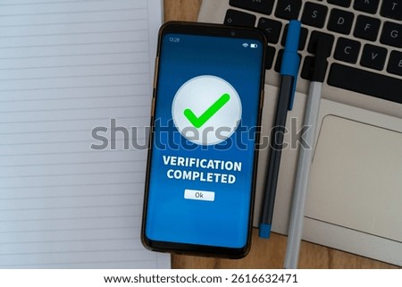 Biometric verification completed successfully on smartphone app. Concept of cyber security and KYC.