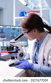 Biotechnologist Woman Scientist Researching With A Microscope In Pharma Lab. Modern Laboratory For Scientific Research With Professional Equipment For Virus Study And Vaccine Science Development