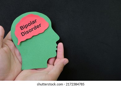 Bipolar Disorder Patient Care, Recovery, Therapy And Treatment Concept. Hand Holding Human Head Profile With Word Dementia On Brain.