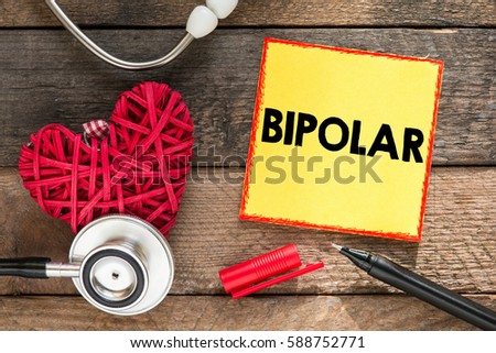 Bipolar. Medicine concept / Yellow Paper sticker with inscription bipolar and stethoscope, medicine concept