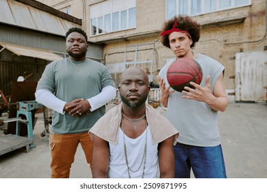 Biracial bros looking at camera while hanging out together in backyard