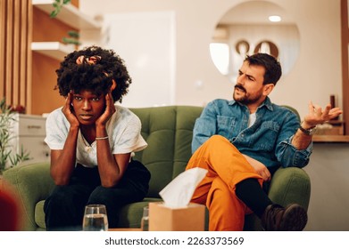 Biracial couple argue in therapy. Diverse spouses marriage counseling. Custody battle, divorce, adoption, alimony or family problem. Focus on a african american woman having a headache. Copy space. - Powered by Shutterstock
