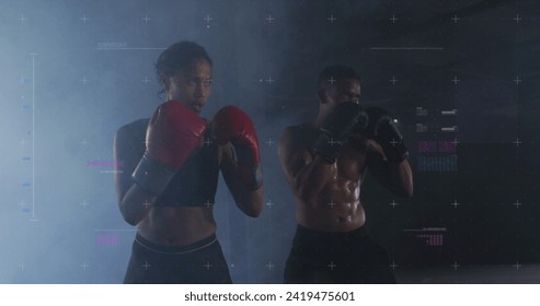 Biracial couple training in a gym, with copy space. They showcase fitness and determination during a boxing workout. - Powered by Shutterstock