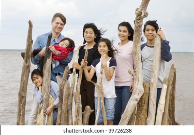 Biracial Family Together At The Beach In Summer