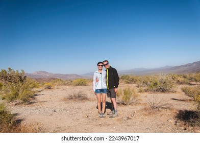 a bi-racial happ couple within the desert landscape of joshua tree national park in sunny california. - Powered by Shutterstock