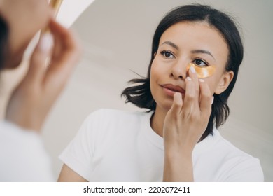 Biracial Lady Skin Care. Young Hispanic Woman Applies Anti Wrinkle Collagen Eye Patches. Anti Age Lifting Serum, Dark Circles Gel Patches. Cosmetology And Dermatology, Beauty And Spa At Home.
