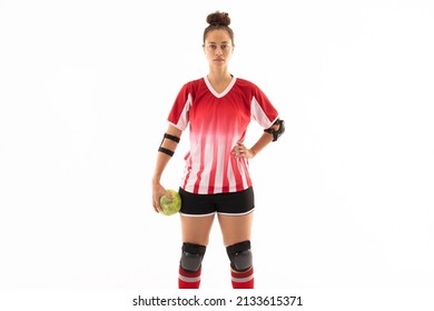 Biracial young female handball player standing with ball and hand on hip against white background. unaltered, copy space, sport, sports uniform, safety, athlete and team handball. - Powered by Shutterstock