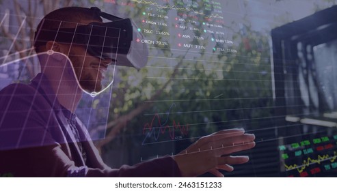 Biracial young man wearing virtual reality headset, interacting with digital data. He has short black hair, light brown skin, and is wearing dark shirt - Powered by Shutterstock