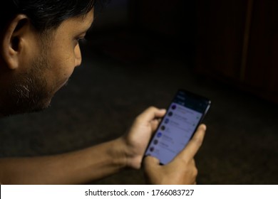 Birbhum, West Bengal / India - June 27th 2020: An Indian Person Is Using Whatsapp Application In Smartphone In A Dark Room With Selective Focus