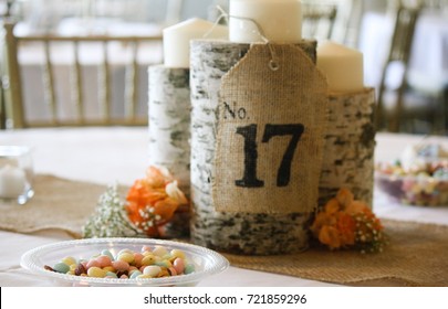 Birch Log Candle Holder With Burlap Stenciled Table Number At Wedding Reception