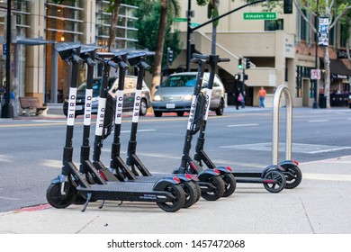 Bird Electric Rideshare Scooters On Sidewalk In City Downtown On Sunny Day. Bird Is A Reliable Last Mile Dockless Electric Scooter Rental Service - San Jose, California, USA - July 21, 2019