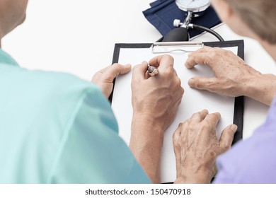 Bird Eye View Of Nurse Taking Notes For A Patient