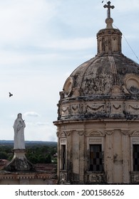 Bird flying towards a dome in  Granada, Nicaragua