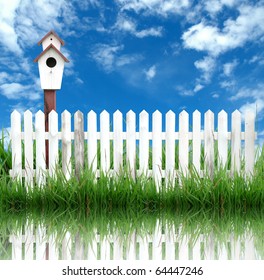 bird house with white fence and blue sky