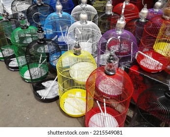 A Bird Trader At The Bird Market In Diponegoro Puts A Bird Cage In Front Of His Shop To Cover His Stand (Surabaya, 13 March 2016)