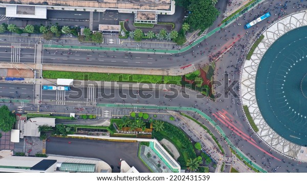 Bird view\
crowd of people doing activities on Hotel Indonesia Roundabout\
Bundaran HI on Sunday morning. Car free\
day